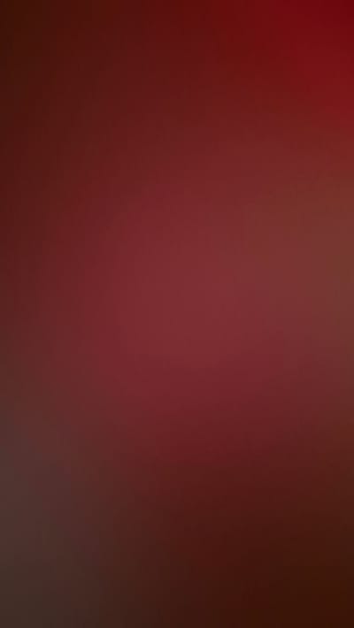 This is a digitally created, abstract image with a deep red, almost burgundy, gradient background. There are no discernable objects, people, or actions depicted. The image is uniformly blurred with slight variations in tone, suggesting a soft, diffused lighting effect. There is no specific location within Цярэніцкі сельскі Савет, Belarus, that this image represents, as it is an abstract creation.