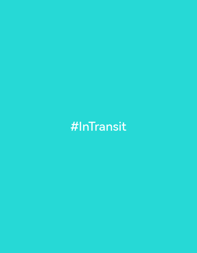 The image displays a solid teal background with white text in the center that reads "#InTransit". The background appears to be a digital image or a graphic design, with no discernible elements that would place it in a specific physical location, such as the city of Oktyabr'skii, Russia. There are no people, subjects, objects, actions, or interactions depicted.