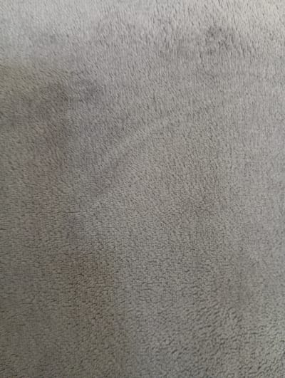 The image displays a close-up view of a gray, fuzzy fabric. There are no people, objects, actions, or interactions visible. The texture appears soft and plush, with a uniform color throughout. The image does not contain any information about Hlynytsi, Ukraine, or any urban environment.