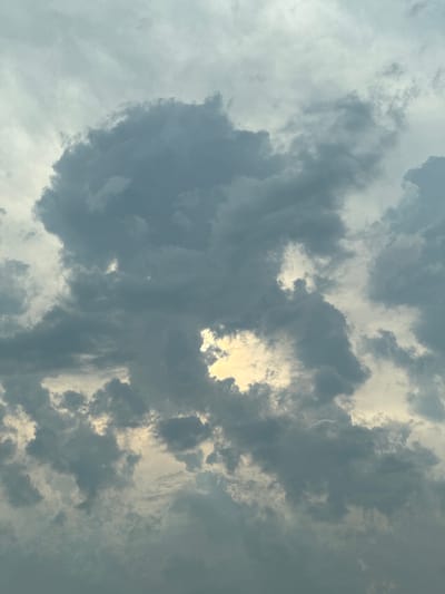 This media file is a photograph of a cloudy sky. The clouds are varied in color and texture, ranging from dark gray to light white. Some clouds appear dense and heavy, suggesting the possibility of rain, while others are wispy and scattered. Sunlight is breaking through in some areas, creating brighter patches and illuminating the edges of the clouds. The overall impression is one of a dynamic sky, possibly indicative of changing weather. There are no visible people, objects, text, or specific location cues within the frame of the image itself, other than what can be inferred about the sky. The time of day is not explicitly indicated but the lighting suggests it could be daytime. The location context provided is Babovo, Bulgaria, which is a geographical setting that does not manifest visually in the image. The photograph captures a natural scene, focusing solely on the atmospheric conditions above.