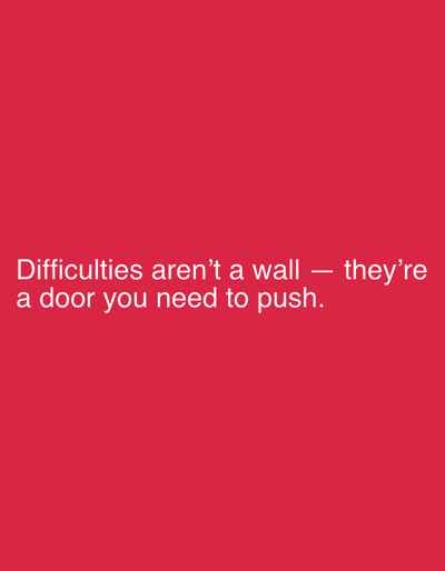 The image is a simple graphic with text on a solid red background. The text, in white, reads: "Difficulties aren't a wall — they're a door you need to push." There are no people, objects, actions, interactions, or environmental elements visible in the image. The location in Pobiedziska, Poland, is not relevant to the visual content of the image.