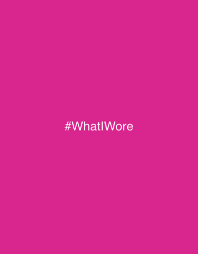 The image is a solid, vibrant magenta background. In the center, the hashtag "#WhatIWore" is displayed in a clean, white sans-serif font. The text is centered both horizontally and vertically on the magenta backdrop. The overall composition is simple, emphasizing the hashtag and its social media context against the striking color.