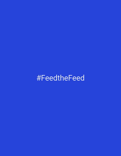 The image shows white text on a solid blue background. The text reads "#FeedtheFeed". The scene is simple and minimalist, with no other objects or subjects visible. There are no indicators of time of day, weather, or specific location beyond the provided context of Târgu Jiu, Romania. The emotion conveyed is neutral due to the lack of visual cues.