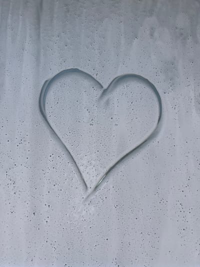 The image shows a heart shape drawn on a surface covered with a light gray foam or suds. The foam is fine and contains numerous small bubbles. The heart is formed by clearing the foam away in the shape of the symbol. There are no people or other objects visible in the image. The location, Areyskoye, Russia, cannot be verified.
