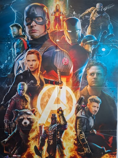 This is a poster for the Marvel movie "Avengers: Endgame," featuring various characters from the film. The characters are depicted in a dynamic composition with dramatic lighting and special effects, including lightning and fire. From top to bottom, and generally left to right, the identifiable characters include Captain America, Thor, Captain Marvel, Iron Man, War Machine, Black Widow, Nebula, Rocket Raccoon, Bruce Banner (Hulk), Thanos, and Hawkeye. The Marvel Studios logo is visible at the bottom. There is no indication of Sinzheim, Germany, or any urban environment in this image.