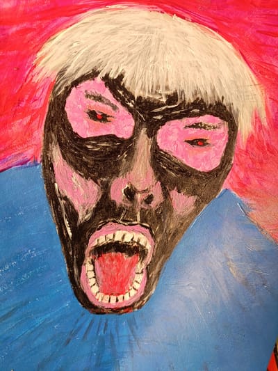 The image is a close-up, low-angle, portrait-style painting of a person's face. The subject has white hair and a black face with pink accents around the eyes and cheeks. The eyes are depicted with red pupils. The mouth is wide open, revealing a red tongue and white teeth. The background is a vibrant mix of pink and blue. The style is expressionistic and abstract. There is no discernible indication of location within Ban Patan, Thailand, or any urban environmental context. The painting appears to be a figurative artwork, likely an acrylic or oil painting on canvas, given the texture and visible brushstrokes.