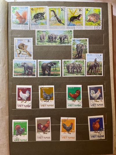 The image shows a page from a stamp album featuring a collection of postage stamps depicting various animals and birds. The stamps are arranged in rows and columns. The top row features stamps with a red squirrel, a turtle, a stoat, an otter, and a hedgehog. The second row displays stamps with elephants. The third row includes stamps with chickens and a turkey. The fourth row features more stamps with chickens. The stamps are from different countries, including Hungary and Vietnam. The album page is brown, and the background suggests it is part of a larger album. There is no indication that this image is related to the city of Kramatorsk, Ukraine.