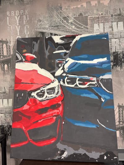 This is a media file containing an image of a painting. The painting appears to be an abstract or semi-abstract representation of a motorcycle or possibly a car, with prominent use of red, blue, and grey colors. The style is bold and painterly, with visible brushstrokes. The subjects are not clearly defined figures but rather forms and colors suggesting mechanical parts. There are no discernible activities or events taking place within the painting itself.
The painting is placed against a textured background that resembles a collage or wallpaper featuring cityscapes, specifically bridges and buildings, with text such as "BROOKLYN 1982" visible. This background provides context for the artwork, suggesting an urban or metropolitan theme. The lighting in the image is artificial, and there are no indications of time of day or weather conditions. The overall mood conveyed by the painting is energetic and dynamic due to the color choices and bold strokes. No emotions are explicitly depicted.
The visible text in the background includes "BROOKLYN 1982". The painting itself does not contain any clearly legible text. The location context provided is Sim, Russia, which is external information about where the media file is relevant and does not appear in the image itself.