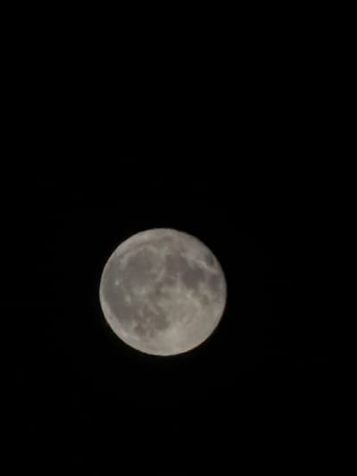 The image shows a full moon against a black sky. The moon is illuminated and has visible craters and surface features. There is no indication of any urban environment or any connection to Constanța, Romania. The scene is entirely astronomical.