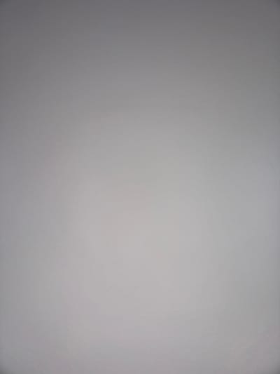 The image is a plain, solid gray surface with a slight variation in tone across the frame, indicative of uneven lighting. There are no discernible objects, people, actions, or contextual elements present that would allow for any determination of a location, including Topolovgrad, Bulgaria.