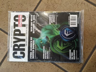 The image shows the cover of Crypto Magazine, Collector's Edition, Issue 10. It features a green-hued wolf illustration and crypto-themed coin graphics. Headlines include "FUSD: Always Up Never Down!", "Win Big with Bitcoin in 2025", "Unmasking Privacy Chains", "Bitcoin's Untold Secret", and "Freedom in the Balance". Taglines mention financial freedom, engineered appreciation, investment strategies, bulletproof security, and CBDCs vs. crypto. The magazine is priced at US $15.00 and is printed in the UK.
