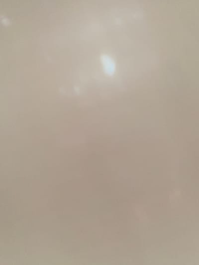 The image displays a diffuse, light-colored surface, likely a wall or ceiling, with several out-of-focus bright spots. There is no discernible detail that would allow for location identification within Kassa, Nigeria, or any other specific environment. The image lacks any subjects, objects, actions, or interactions.