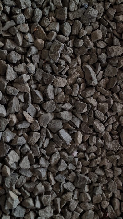 The image depicts a dense collection of gray, irregularly shaped rocks. The rocks vary in size, with some being noticeably larger than others. The composition fills the entire frame, creating a textured surface of stone. No people, specific objects beyond the rocks, actions, or interactions are visible. The environment is a collection of rocks. Karawang, Indonesia is not discernible from the image.