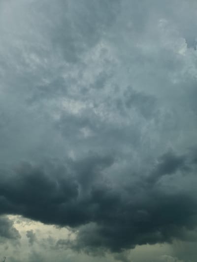The image shows a cloudy sky over Rzeszów, Poland. The clouds are dark and heavy, suggesting an approaching storm. The sky is overcast, with no sun visible. The overall impression is one of gloom and impending weather. There are no people, subjects, or objects visible in the image, other than the clouds themselves.