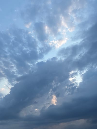The image shows a sky filled with dark, moody clouds and patches of lighter, brighter clouds. The lighting suggests either dawn or dusk. The scene is devoid of any specific landmarks or identifying features that would place it within the city of Toruń, Poland, or any other urban or natural environment. The image is purely a sky-scape.