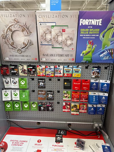 This image captures a retail store display, rotated clockwise by 90 degrees, featuring video game-related products and digital content. The scene is brightly lit, indicative of an indoor commercial environment.

On the left, two large promotional posters are visible. The top poster advertises "FORTNITE" with a "COLOR SPLASH JELLIE OUTFIT!" offer available from 1/13/2025 to 2/16/2025 upon redeeming a V-Bucks card. Below it, a poster for "SID MEIER'S CIVILIZATION VII" announces its availability on "FEBRUARY 11" for PS5, Xbox, and Nintendo Switch, showing various game box art mockups. A small blue sign to the far left states, "Check prices here or with our app."

The central part of the image is dominated by a gray pegboard displaying numerous gift cards. These include PlayStation Store cards, Nintendo eShop/Online cards (some marked "$10", "$20", "$35"), Pokémon GO cards (with denominations like "1,250" and "3,300" coins), various Mario-themed cards, Xbox gift cards (some "$25", "$50", "$100"), Xbox Game Pass cards, Roblox gift cards, Fortnite V-Bucks cards, Steam gift cards, and Google Play cards. Smaller game boxes for "Call of Duty" and "Assassin's Creed Shadows" are also present at the bottom of the pegboard.

To the right, a red and white informational panel titled "DIGITAL GAMES & ADD-ON CONTENT" outlines a three-step purchase process: "1 SELECT" (a full game download or add-on content card), "2 PURCHASE" (at the register, with a download code printed on the receipt), and "3 KEEP" (your receipt). An electrical outlet and conduit run vertically along the right side of the pegboard.