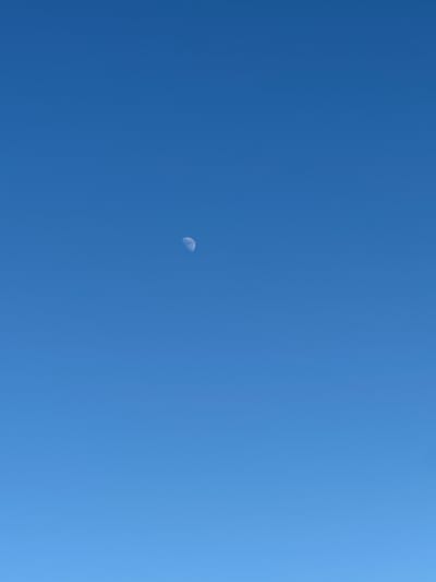 A crescent moon is visible in the upper left quadrant of a clear, bright blue sky. The image appears to be a photograph taken from an outdoor location, likely during daylight hours given the brightness of the sky. There are no other visible objects or subjects in the frame, making it a minimalist composition focused on the celestial body against the expanse of the sky. The location in Tobyl, Kazakhstan cannot be determined from the visual information alone.