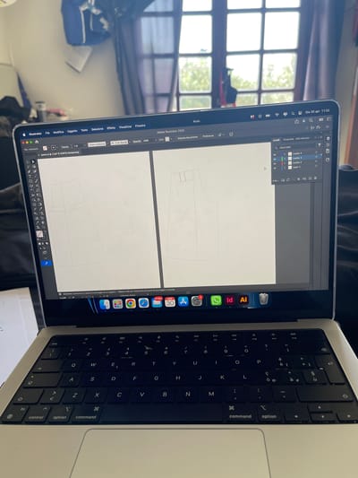 The image displays an open silver Apple MacBook laptop, featuring the Adobe Illustrator 2026 software on its screen. The laptop is situated indoors, with a window showing natural light and blurred outdoor scenery in the background.
On the screen, a digital pattern resembling parts of trousers or shorts is being worked on. The Adobe Illustrator interface is set in Italian, with visible menu options such as 'File', 'Modifica' (Edit), 'Oggetto' (Object), 'Testo' (Text), 'Seleziona' (Select), 'Effetto' (Effect), 'Visualizza' (View), and 'Finestra' (Window), along with 'Aiuto' (Help). The 'Livelli' (Layers) panel is open on the right, showing 'Livello 4', 'Livello 3', 'Livello 2', and 'Layer 1'. A tooltip on the canvas area states: 'Seleziona il percorso o il punto di ancoraggio di un oggetto | Malusc+clic per selezionare più punti di ancoraggio o tracciati' (Select the path or anchor point of an object | Shift+click to select multiple anchor points or paths). The open file is named 'pants.ai' and viewed at 11.67% zoom.
The top menu bar indicates the time and date: 'Gio 30 apr 11:02' (Thursday, April 30, 11:02 AM). The laptop's dock, partially visible at the bottom right of the screen, includes icons for Adobe Illustrator, Adobe InDesign, and WhatsApp. Notification badges are visible on some icons: '2' on Settings, and a calendar-like icon shows '30 APR' and '37,861'. The black QWERTY keyboard in the foreground features an Italian layout, identifiable by accented characters. This scene suggests a creative design activity, possibly fashion or textile pattern making, occurring during the daytime in Su Masu/Elmas, Italy.