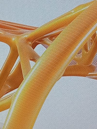 The image shows a close-up, abstract view of an orange, metallic structure, possibly part of a bridge or an architectural element. The structure features curved beams and diagonal supports, with a textured surface that reflects light, creating a gradient of orange and yellow hues. The background is a light blue-gray color with a visible canvas-like texture. There are no people, animals, or recognizable landmarks visible in the image, and therefore no specific location in Buțeni, Moldova can be identified. The composition is purely focused on the geometric forms and textures of the orange structure.