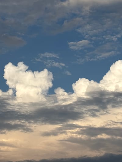 The image shows a cloudy sky. The clouds are white and fluffy in some areas, while others are gray and dark. The sky is blue, indicating daytime. There are no people or objects visible in the image, nor any buildings or other structures that would indicate a specific location in the city of Новый Кинер, Russia. The scene is purely natural, focusing on the atmospheric conditions.