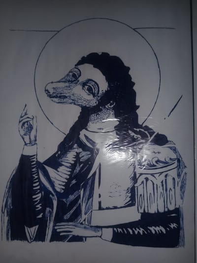 The image is a drawing in blue ink on white paper. It depicts a figure with a reptilian head, human-like body, and wearing religious vestments. The figure has a halo around its head, suggesting a religious or saintly depiction. The drawing style is illustrative, with clear lines and some shading. There is no discernible background or environment depicted that would indicate a specific location in Gulbag, Uzbekistan, or anywhere else. The image appears to be a standalone artwork.