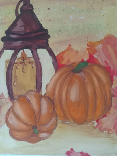A painting depicts an autumnal scene with a rustic lantern, a lit candle inside, and two pumpkins. The lantern is dark brown with cream-colored panes, and the candle emits a warm glow with drips of wax. To the right of the lantern, two pumpkins are prominently displayed: a larger, rounder one in the foreground and a smaller, slightly flattened one to its left. Scattered around the objects are stylized, fallen leaves in shades of orange, pink, and red. The background is a textured, light green-yellow wash with flecks of red and white, suggesting a whimsical, fall atmosphere. There are no people, actions, or interactions depicted. The painting does not contain information about its location in Kielce, Poland.