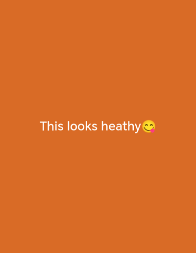 The image displays a solid orange background. Centered horizontally, slightly above the vertical midpoint, white text reads "This looks heat hy". Immediately following this text is a yellow emoji depicting a smiling face with an open mouth and a pink tongue extending to the right. No people, physical objects, actions, interactions, or discernible environmental features are present in the image. The image does not depict any physical location in the city of Olambe, Nigeria, or elsewhere.