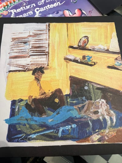 An oil painting on canvas depicts a distorted, abstract scene. A yellow wall with vertical elements dominates the left side, contrasted by a dark, formless figure on the right, accented with blue strokes. Below the wall, a series of dark, linear shapes resembling a keyboard stretches horizontally. The composition is unclear, with thick brushstrokes and undefined forms creating a sense of disorientation.