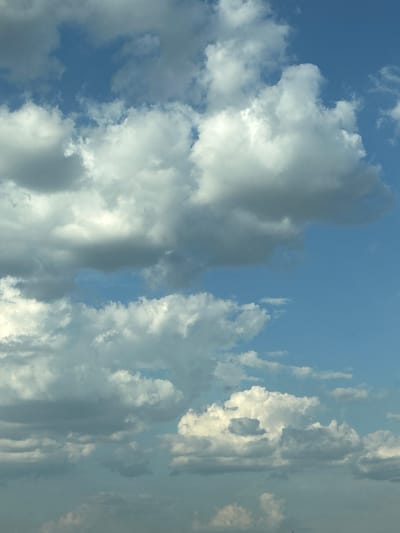 The image is a photograph of a sky filled with clouds. The clouds are a mix of white and gray, with some areas appearing brighter where the sun is hitting them, suggesting it is daytime. The sky is blue, indicating clear weather in between the cloud formations. There are no people or man-made objects visible in the frame, making the subject purely natural. The image appears to be taken from a low angle, looking upwards at the sky. The overall mood is serene and expansive, typical of a sky observation. There is no visible text in the image. The location context provided is Tsalapitsa, Bulgaria, which places the scene in a specific geographical area.