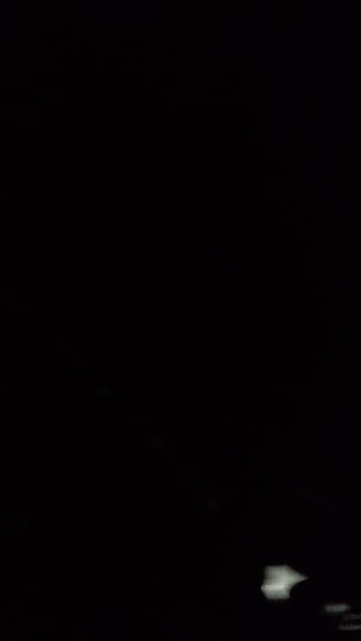 The image is a very dark, grainy, and low-resolution photograph. It appears to be taken at night or in extremely low light conditions. The majority of the image is black, with some faint, indistinct greyish-white areas visible. These lighter areas are amorphous and lack clear definition. It is impossible to discern any specific objects, people, or actions within the scene due to the poor quality and darkness. There is no discernible information about the location in Venta De La Romera, Spain, or any other environmental details.