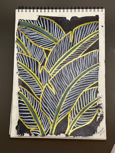 The image displays a close-up, overhead view of a drawing on a spiral-bound sketchbook page. The artwork is an abstract depiction of stylized leaves or feathers, rendered with dark grey and white stripes. These striped elements are outlined and intersected by bold, curving lines in bright yellow and dark green. The background is a solid black, with small flecks of purple and gold speckles scattered throughout. The paper shows a rough, textured edge along the bottom and left side, suggesting it's a torn or deckled edge. The sketchbook is placed on a dark, flat surface. In the bottom right corner of the drawing, there is a handwritten signature and date: "F.F. QUINT 14-1-26". The location of Fañabé, Spain is not depicted in the image and cannot be inferred from the visual information provided.