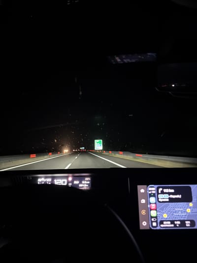 The image shows the interior of a car driving at night on a highway. The dashboard displays the speed as 120 km/h and the temperature as 23°C. A navigation screen shows a route with 113 km remaining and a destination labeled "Пераляк". The surrounding environment is dark, with the road illuminated by headlights and streetlights. The location is identified as Tsalapitsa, Bulgaria.