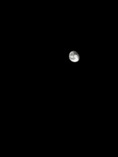 The image depicts a nighttime celestial observation from the vicinity of Griboyedov, Armenia. The primary subject is the Moon, positioned in the upper right quadrant of the frame, against a completely black sky. The Moon is illuminated in a gibbous phase, revealing distinct surface features including multiple craters and areas of varying luminosity, indicative of lunar maria and highlands. No other celestial bodies, atmospheric phenomena, or terrestrial objects are visible.