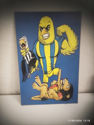 This is a photograph of a painting on a blue background. The painting depicts a cartoonish scene with three animal characters. On the left, a large yellow bird-like creature with blue and yellow striped clothing is standing, facing to the right. Its beak is open, and it appears to be screaming. Below this creature, another bird, this one black and white striped with a yellow beak, is depicted with its wings spread and mouth open, also appearing to be screaming. On the right side of the painting, a lion-like creature with a mane, wearing a red and yellow striped shirt, is facing left. The lion is reaching out and holding the beak of the larger yellow bird. The lion has a distressed expression, with its tongue sticking out. The overall scene suggests a moment of conflict or playful struggle between the characters. The image has a timestamp in the upper right corner that reads "17/06/2026 13:18". The setting appears to be indoors, possibly a wall where the painting is displayed. The lighting suggests it is daytime.