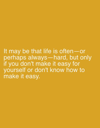 The image is a close-up shot of text on a solid yellow background. The text reads: "It may be that life is often—or perhaps always—hard, but only if you don't make it easy for yourself or don't know how to make it easy." There are no people, objects, or environmental features present in the image. The background is a uniform, textured yellow. The image is centrally framed, with the text occupying the lower half. The location in Hofheim, Germany is not depicted or alluded to in the image.
