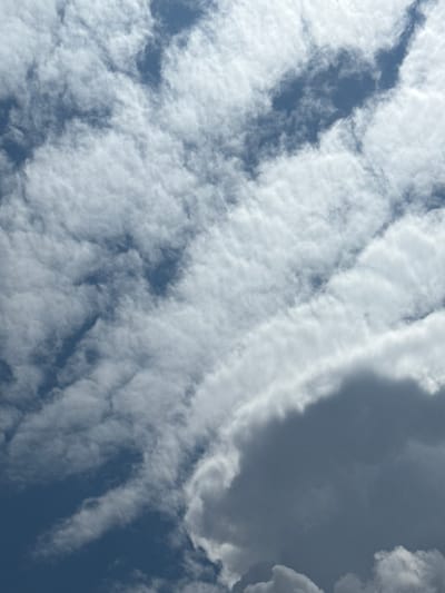The image shows a sky filled with clouds. The clouds are varied, with some appearing light and wispy, while others are darker and more dense. The sky is a deep blue in the areas not obscured by clouds. The image appears to be a close-up shot of the sky, with no ground visible. It is not possible to determine the location of Uchterek, Uzbekistan from this image alone.