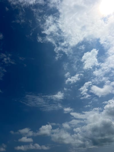 The image shows a blue sky with white clouds scattered throughout. The clouds are mostly clustered towards the right side of the image, leaving the left side of the image a bright, clear blue. The image was taken in Santa Fe, Costa Rica, at the coordinates 9.642 latitude and -85.168 longitude. The image does not contain any people or objects.