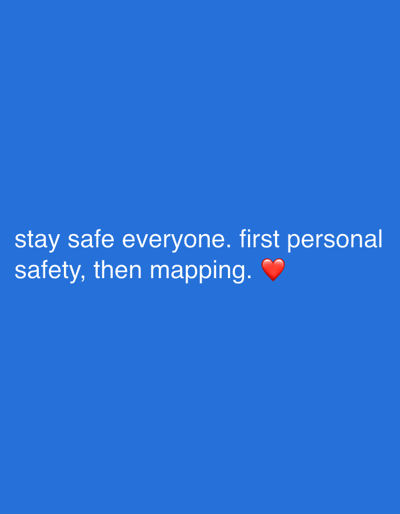 The image displays white text positioned towards the lower third of a solid blue background. The text reads: "stay safe everyone. first personal safety, then mapping." A red heart emoji is situated to the right of the word "mapping." No discernible physical environment, specific objects, people, or actions are depicted within the image frame. The referenced location of Longone al Segrino, Italy, is not visually verifiable from the provided content.