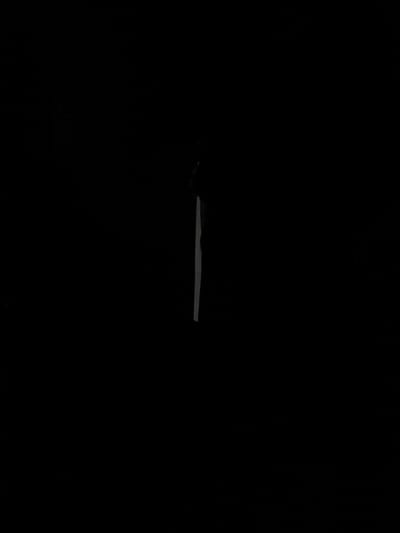The image is a low-light photograph, possibly taken at night. In the center, a horizontal, elongated gray object is barely visible against the black background. Based on the prompt mentioning Chuprino, Russia, it is reasonable to infer this might be a street or road segment. Given the lack of detail, no further elements or actions can be determined.