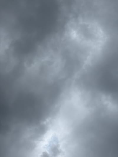 The image is a low-angle shot of a cloudy sky. The clouds are a mix of dark gray and lighter shades, suggesting an overcast or approaching storm. There are no discernible landmarks or elements that would indicate a specific location within Grapevine, Texas, or any other city. The image is purely an abstract composition of cloud formations.