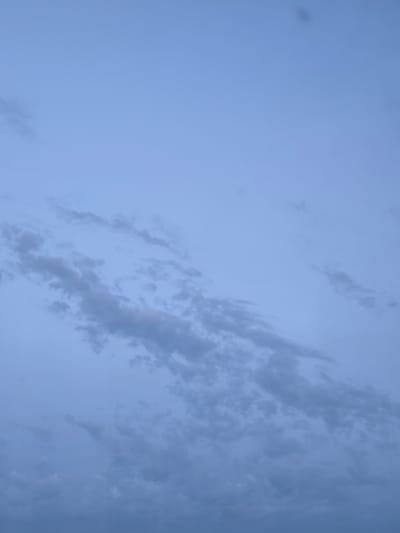 This media file depicts a clear sky with scattered clouds, likely taken in Apsheronsk, Russia. The lighting suggests it is either dawn or dusk, as the sky is a soft blue with a hint of purple. The clouds are wispy and thin, indicating fair weather. There are no people or objects visible in the frame, and no text is present. The scene is serene and peaceful, evoking a sense of calm and tranquility. The image focuses solely on the natural beauty of the sky, highlighting the subtle variations in color and cloud formations.