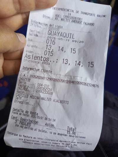 The image shows a close-up of a bus ticket. The ticket is for Interprovincial de Transporte ValencIA, located in Quevedo, Ecuador, on Avenida Walter Andrade Fajardo (based on the RUC and "Direc"). The destination is Guayaquil. The bus number is 016, departing May 31, 2026, at 09:20, from platform 015. The ticket reserves seats 13, 14, and 15. The ticket is for a passenger named Castillo Medina Walter Adalberto (DNI/RUC 0906233028). Three passengers are traveling for a total cost of $15.00. The ticket was printed on May 31, 2026, at 08:54:34. A link to download an electronic invoice is provided. A hand is also visible holding the ticket.