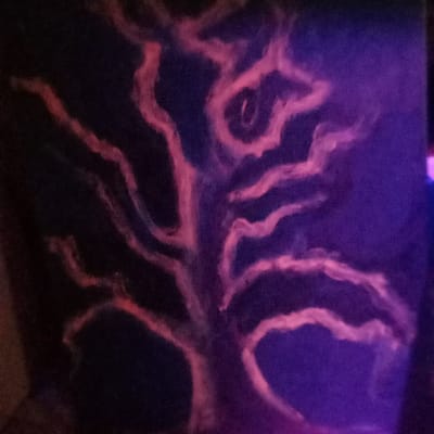 The image depicts an abstract painting of a tree rendered in pink and purple hues against a dark background. The location, based on the coordinates 46.786 latitude, -92.101 longitude, is likely in a gallery or studio in Duluth, Minnesota, United States. No people or objects are present in the image. The artwork is likely a contemporary abstract piece, featuring fluid brushstrokes and a minimalist aesthetic. The painting evokes a sense of mystery and tranquility.