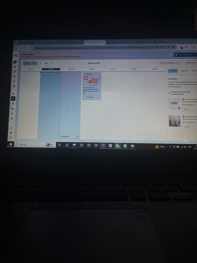 The image shows a laptop screen displaying a social media content planner interface, likely Meta Business Suite, for Instagram. The planner is set to June 2026 and shows a calendar view with individual days. The left sidebar contains navigation icons. A cursor is visible, indicating user interaction. The time is indicated as 3:00 PM on a specific day within the planner. On the right side of the screen, there are sections for "Consejos" (Tips) and "Publicaciones con más visualizaciones" (Publications with more views), with examples of past posts. The bottom of the screen shows the Windows taskbar with various open applications and icons. The image appears to be taken in an indoor setting, likely a home or office, as suggested by the visible laptop and keyboard. The location of San Luis, Peru is not depicted or referenced in this image.