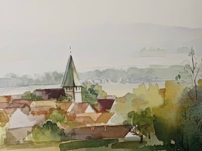 This watercolor painting depicts a village scene with a prominent church spire. The village is nestled amongst rolling hills and trees, with a body of water in the distance. The architecture suggests a European setting, potentially Ossenzijl, Netherlands, given the context.
The painting is rendered in soft, muted watercolors, creating a hazy and atmospheric effect. The time of day appears to be late afternoon or early evening, as indicated by the warm, diffused light and the subtle shadows. The weather seems calm and pleasant, with a light mist or haze softening the distant landscape.
The foreground is dominated by a cluster of buildings with terracotta-tiled roofs, characteristic of rural European architecture. Lush green trees and foliage surround the village, adding a sense of depth and natural beauty. The church spire, painted in shades of green and brown, stands as a central focal point, its pointed roof reaching towards the pale sky.
In the background, layers of hills fade into the distance, rendered with washes of soft grey and blue, suggesting a tranquil and expansive landscape. The overall mood of the painting is peaceful and serene, evoking a sense of quiet charm and rustic beauty. There is no visible text in the image.