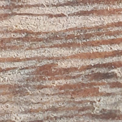 The image shows a close-up, abstract view of a textured surface with horizontal bands of light and dark brown. The texture appears granular or slightly rough. There is a watermark in the bottom left corner that reads "LEXDEN DIGITALS" in white cursive font. The image does not depict any specific location in Edu Town, Nigeria, nor does it contain any people, subjects, objects, or actions. It is solely a textural close-up.