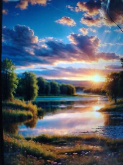 This is a high-angle, full shot of a vibrant landscape painting depicting a serene body of water reflecting a dramatic sunset. The sky is a gradient of deep blue at the top, transitioning to a warm blend of pink, orange, and yellow hues as it nears the horizon. Scattered clouds, illuminated by the setting sun, add depth and texture to the sky. The sun itself is a bright, radiant orb, casting visible rays of light across the scene.
In the foreground, the left bank of the water is covered in lush green grass and wildflowers in various shades of yellow, orange, and purple, suggesting a meadow. The right bank appears to be composed of pebbles and rocks. A dense line of trees, with lush green foliage, forms a backdrop across the mid-ground, lining the far side of the water. The water is calm and glassy, perfectly mirroring the colors of the sky and the surrounding trees.
The painting's style is impressionistic, with soft brushstrokes and a focus on capturing the play of light and color. There are no people or animals visible in the scene, and no identifiable structures or landmarks to suggest a specific urban or rural location within Qorowul, Uzbekistan. The overall mood of the image is peaceful and idyllic.