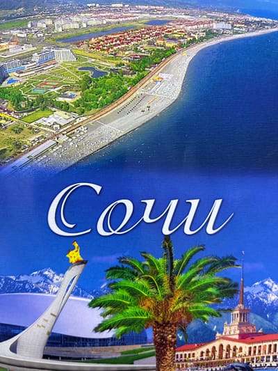 This image is a collage depicting different scenes of Sochi, Russia, not Abaza. The top portion shows an aerial view of a coastal city with buildings, green spaces, a beach, and the sea. The bottom portion features a close-up of a palm tree in front of snow-capped mountains and a white Olympic torch sculpture with a flame. To the right of the palm tree is a building with a spire, resembling a train station, and a dolphin sculpture. The word "Sochi" is written in large white cursive letters across the blue sky in the lower half of the image. There are no people visible in the frame.