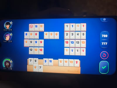 The image shows a screen capture of a Rummikub game being played on a mobile device.

The Rummikub board displays multiple sets and runs of tiles, including runs of "1", "2 3 4 5", "13"s, and sets of "8", "9", and "12". The board also shows individual tiles of "4", "5", and "6".

At the bottom of the screen, Dani's rack of tiles is visible. The tiles are: "7", "9", "8", "7", "3", "11", "5", "11", "13", and "2".

Player avatars and scores are visible on the left side of the screen. Emma is at 4 tiles, Franz is at 3 tiles, and Dani is at 10 tiles. The right side of the screen has buttons to select 789 or 777, undo and confirm.

There is no information available in this image about the city of Mitchells Plain, South Africa.