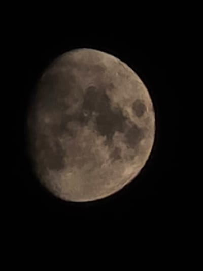 The image shows a close-up, slightly out-of-focus view of the moon against a black background. The moon is partially illuminated, revealing surface features such as craters and maria. The scene is entirely dark, suggesting it was captured at night. There is no discernible information about the city of Montrouge, France, or any people, subjects, or actions within the image.